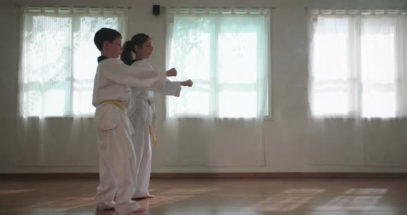 Slow motion footage of young kids practicing martial arts