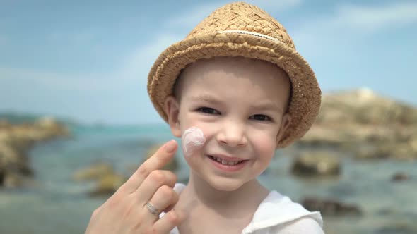 Mom Masks Her Son with Sunblock Cream