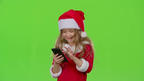 Kid Girl in an Embrace Photographed on a Smartphone. Green Screen