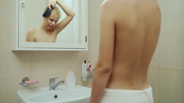 Handsome Man Looking Face In Front Of Mirror. Sexy Manat Bathroom Comb Hair