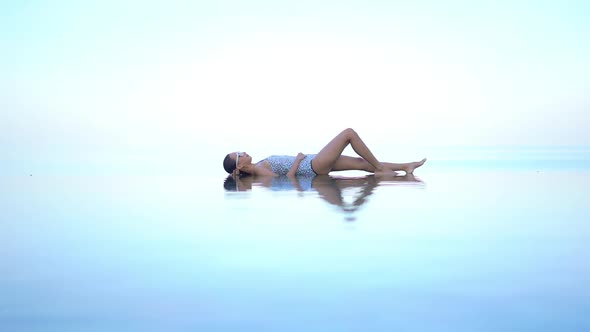 Young asian woman enjoy around outdoor swimming pool for leisure