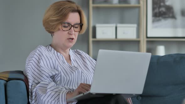 Woman Online Video Chat on Laptop at Work