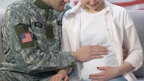 American Serviceman Stroking Pregnant Wife Belly, Family Planning, Young Couple