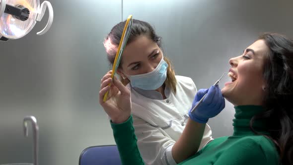 Dentist and Patient Holding Mirror.