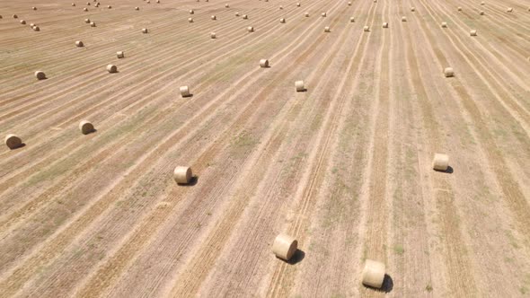 Aerial View of Straw Fields with Bales in Rural Area