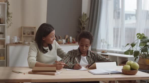 Mom Kissing Son Doing Homework