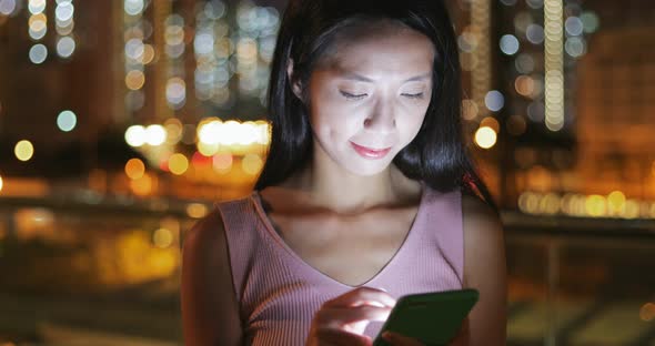 Woman use of cellphone at night 