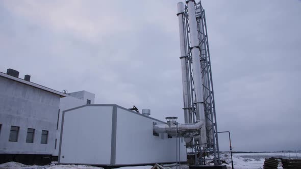 Production Tower with Pipes Near Gas and Oil Refinery Plant