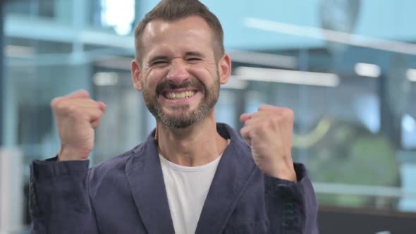 Excited Middle Aged Businessman Celebrating Success