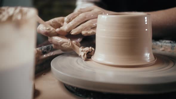 Man Potter Working on Potters Wheel Making Ceramic Pot From Clay in Pottery Workshop