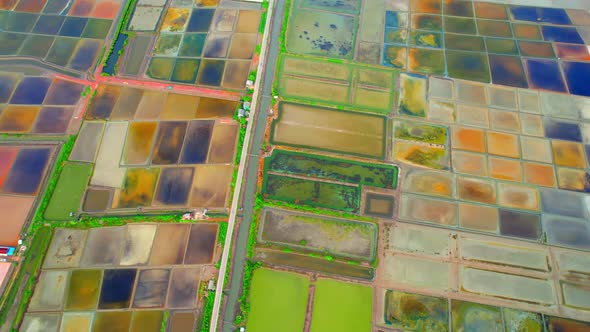 An aerial view from a drone flying over a salt fields, salt production.