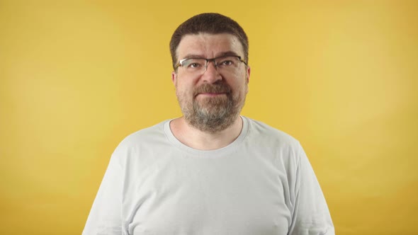 Caucasian middle aged man wearing glasses with beard showing blah blah blah gesture