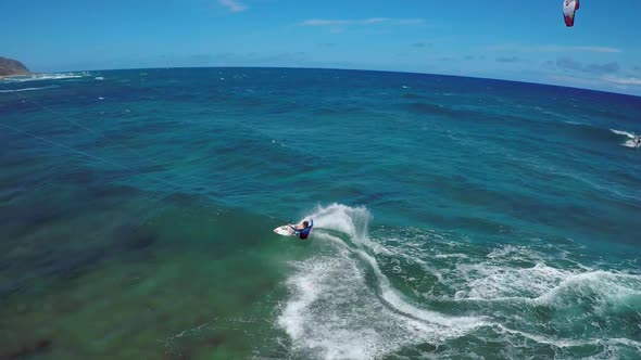 Aerial view of a man kitesurfing in Hawaii