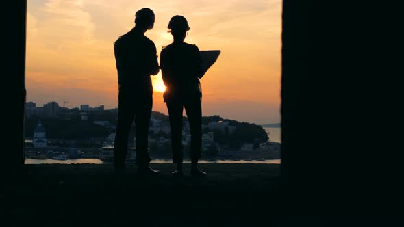 Architects Working on a Sunset Background