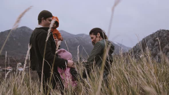 back view of active Family  with kids enjoying valley and mountain view in Montenegro