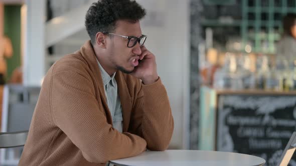 African Man Talking Smartphone Cafe