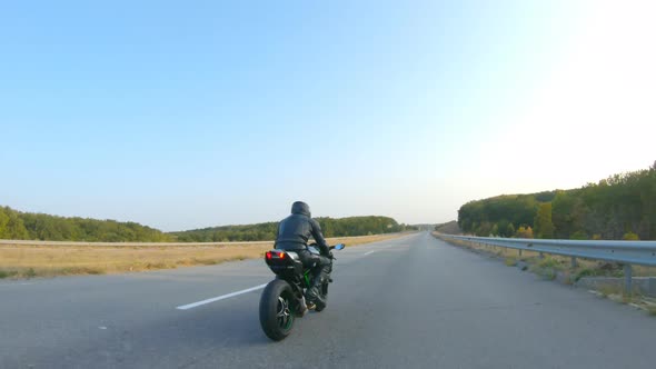 Follow to Motorcyclist in Helmet Riding on Sport Motorbike at Highway