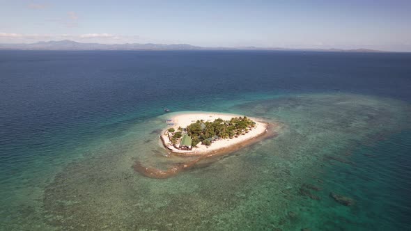Drone flying over tropical south sea island in Fiji on a sunny clear day.