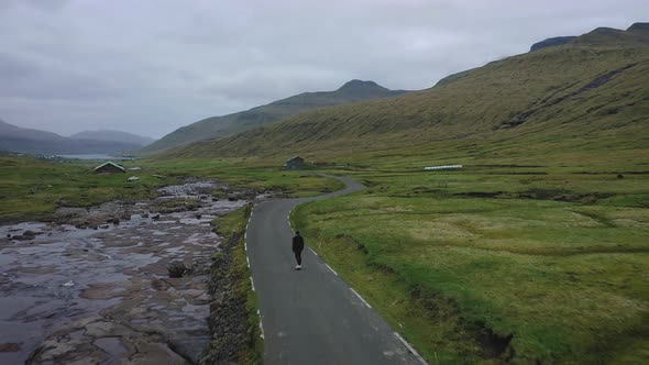Young Skater Riding a Skateboard Through the Beatiful Scenery of Faroe Islands