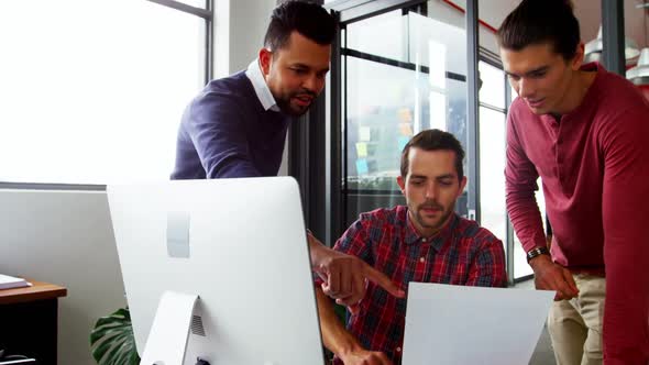 Business executive interacting with each other while working