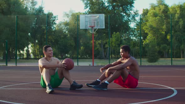 Shirtless Fit Streetball Player Relaxing on Court