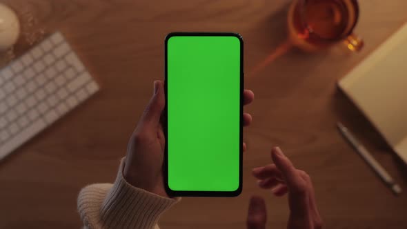 Close Up of Cell Phone with Green Screen in Female Hands