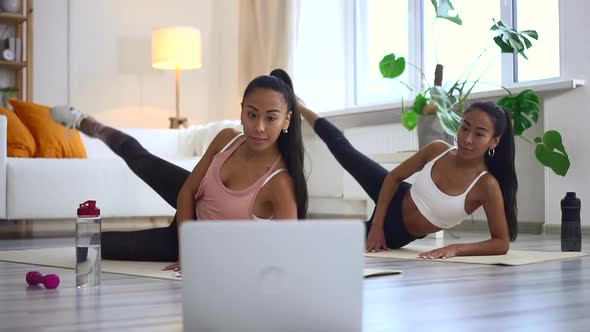 Online Fitness Workout By Mixed Race Sisters Watching Video