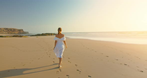Young Joyful Girl in Long Dress Walks on Beautiful Sea Sand Beach of Amazing Paradise Island in