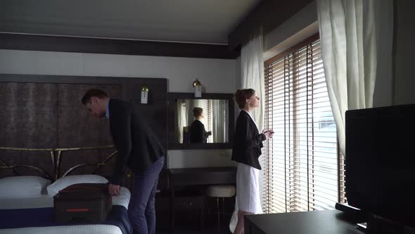 Adult Man and Woman Arrived in Modern Hotel. Girl Comes To the Window and Look on It