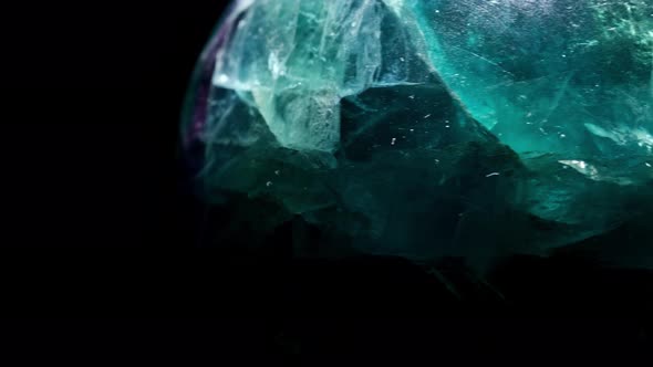 Macro Mineral Stone Fluorite Crystal on a Black Background Close-up