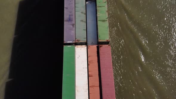 Cargo Ship Loaded With Bulk Of Shipping Containers Sailing At Oude Maas River In Netherlands. - aeri