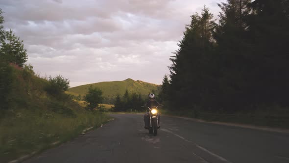 Man Riding Motorcycle on Windy Mountain Asphalt Road