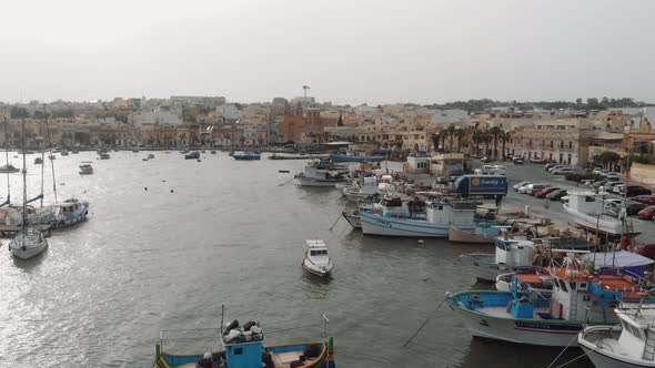 Aerial Push In Shot Over Fishing Boats in Marsaxlokk Malta