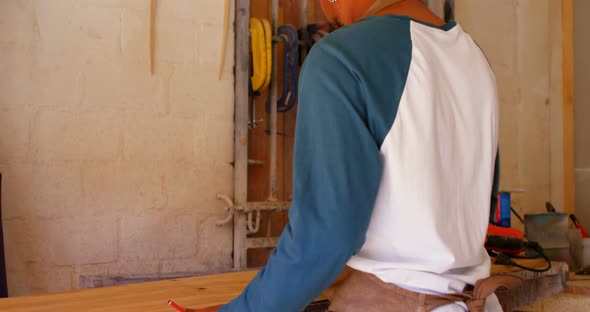 Surfboard maker polishing surfboard