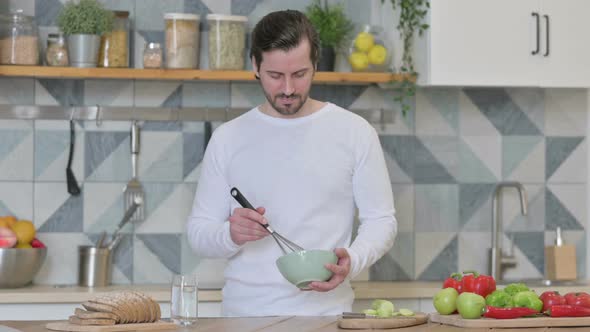 Healthy Young Man Cooking in Kitchen