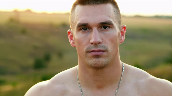 Portrait of Muscular Strong Man After Training Looking at Camera, Sportsman with Bare Torso Outdoors