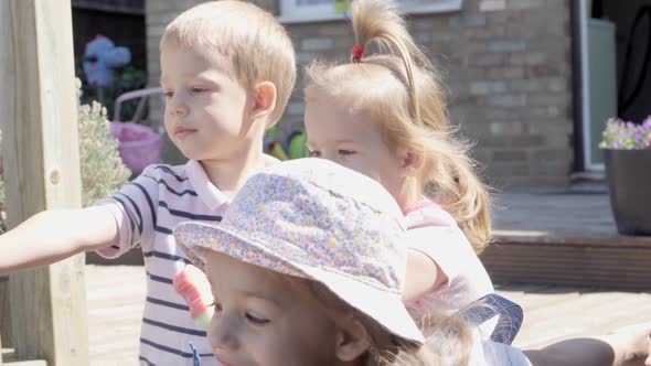 Three Cute Little Children Enjoys Delicious Ice Cream Cone