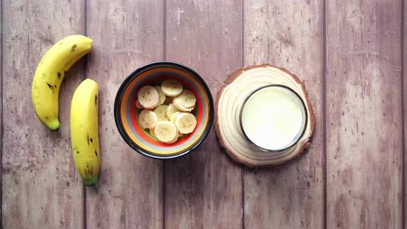 Glass of Milk and Banana on Table at Morning