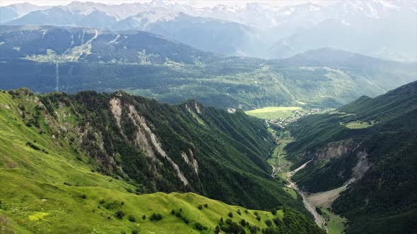 Aerial drone view of nature in Georgia. Caucasus Mountains, greenery, valley, mountain river, villag