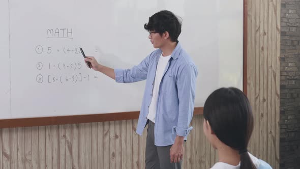 Teacher is teaching in the classroom