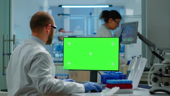 Researcher Looking at Chroma Key Display in Modern Equipped Lab