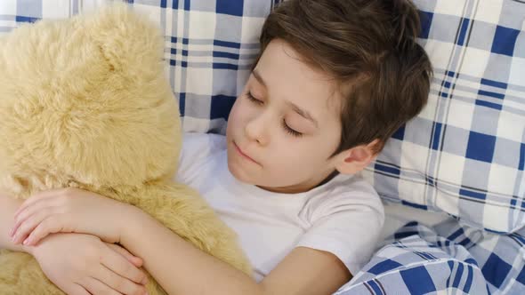 Caring Mother Holding Head on Sick Son Forehead