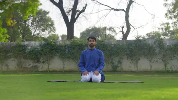 Diamond Yoga Pose or Thunderbolt Yoga Pose or Vajrasana is being done by an Indian man