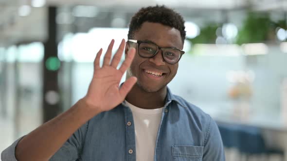 Portrait of Young African Man Waving Welcoming