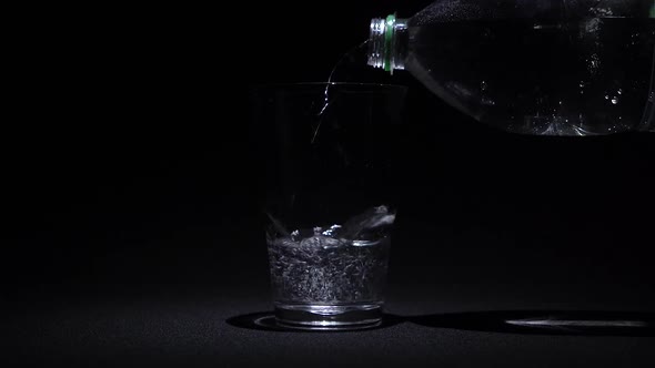 Pouring water into the water cup with visible casting bottle.