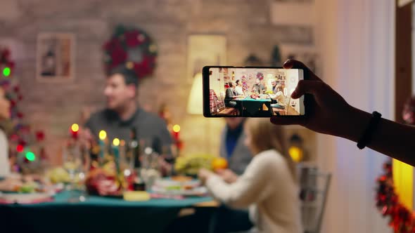 Girl Taking a Family Portrait with Her Phones