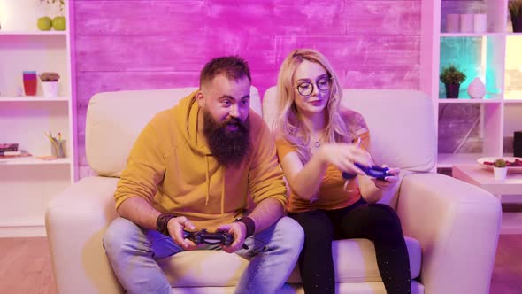 Female Gamer Playing Online Video Games with Her Boyfriend