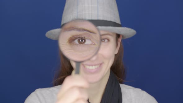 Funny Girl Looking Throw Magnifier To the Camera 