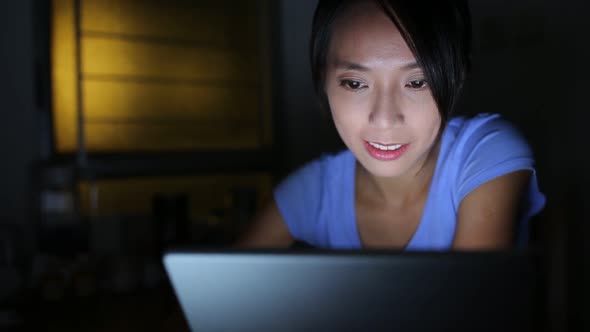 Woman using tablet at night