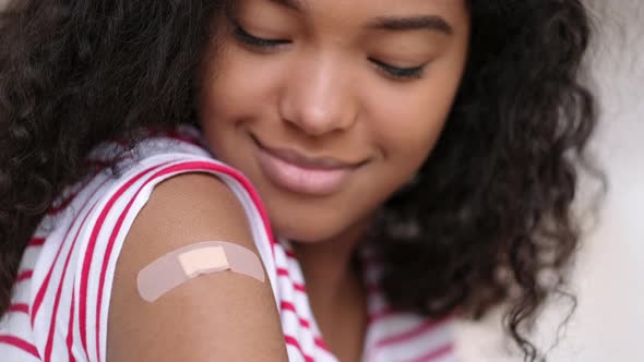Vaccinated African American Woman Showing Arm with Medical Plaster Patch Plaster On Shoulder Black